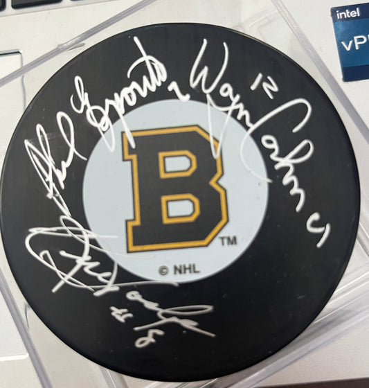 The Legendary ESPO line signed puckby Phil Esposito, Ken Hodge & Wayne Cashman with